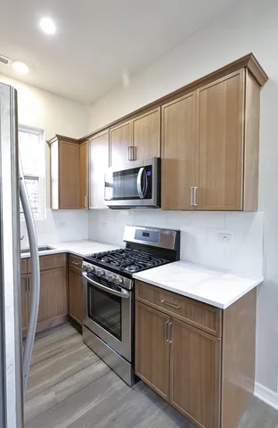 a kitchen with a sink stove and microwave