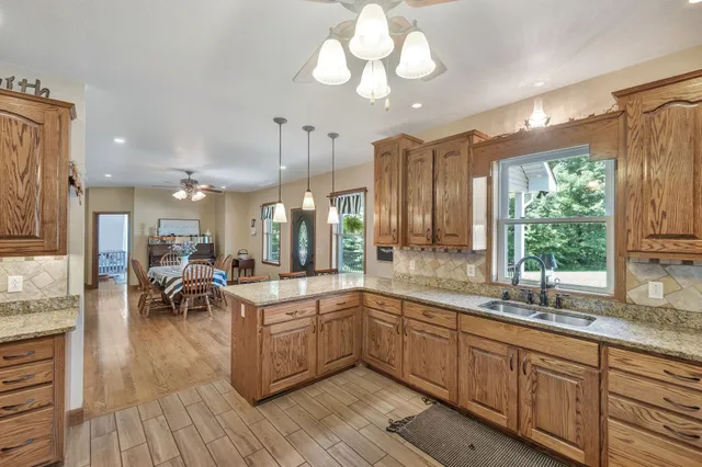 a kitchen with a sink window and cabinets