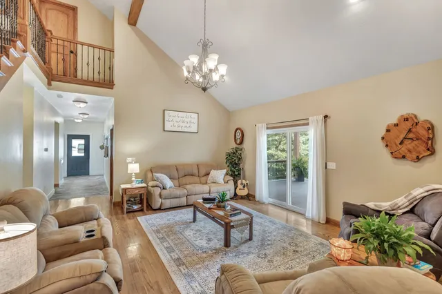 a living room with furniture and a chandelier