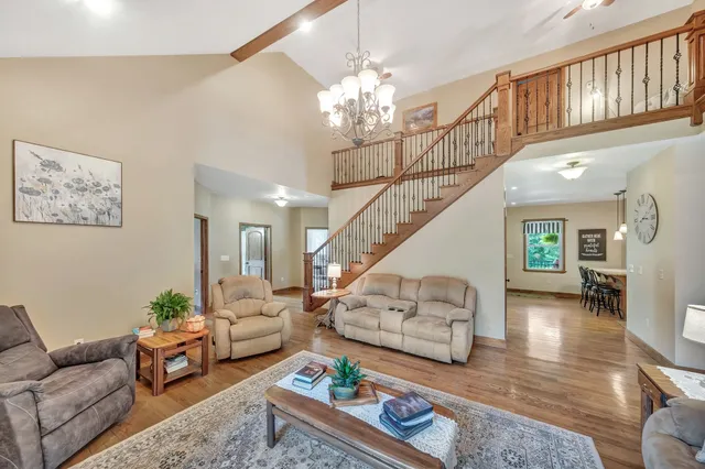 a living room with furniture and a chandelier