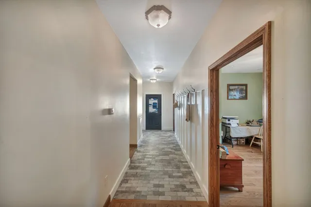 a view of a hallway with closet and a couch