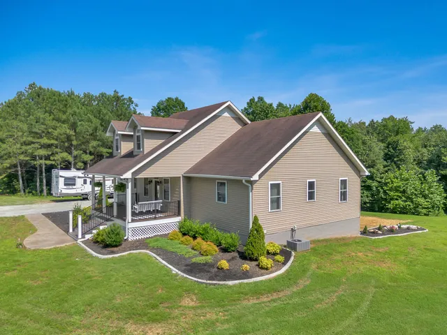a front view of house with yard and green space