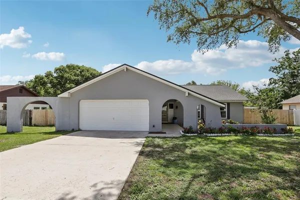 a front view of house with yard and trees