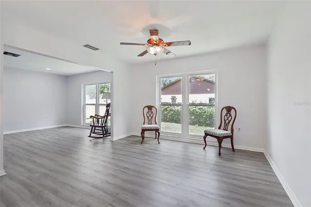 a view of a workspace with furniture window and wooden floor