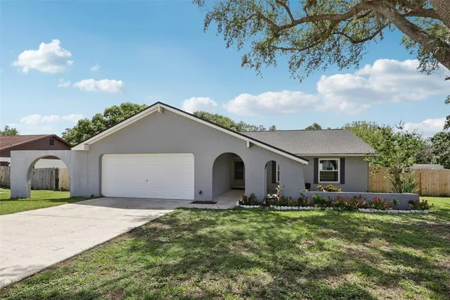 a front view of house with yard and trees