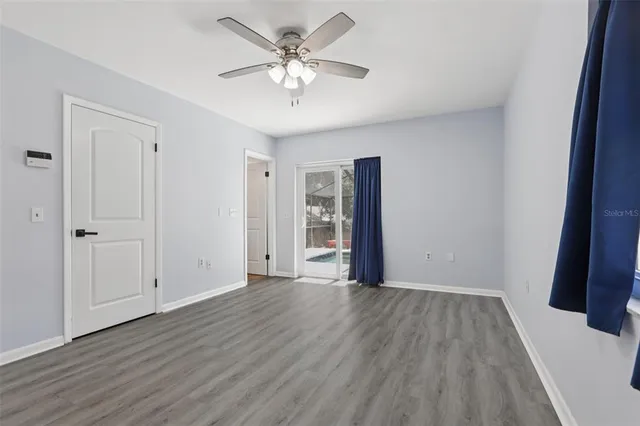 a view of a room with wooden floor ceiling fan