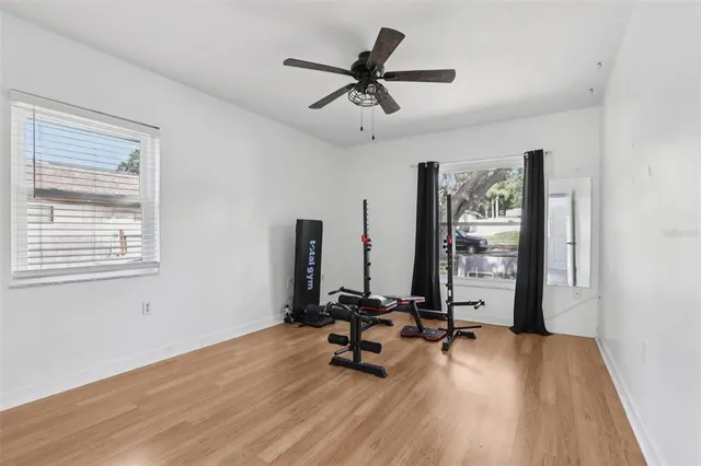 a dining room with furniture and a large window