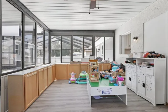 a view of an empty room with furniture and a large window