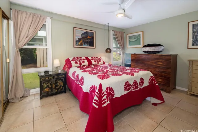 a bedroom with a bed and dresser with mirror