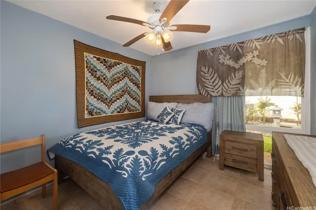 a bedroom with a bed and a painting on the wall