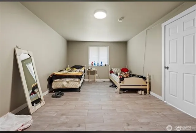 a bedroom with furniture and a window