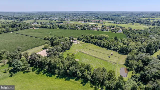 a view of a roof deck with couches and wooden fence