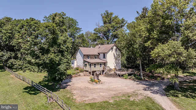 a view of a hallway with wooden floor and stairs