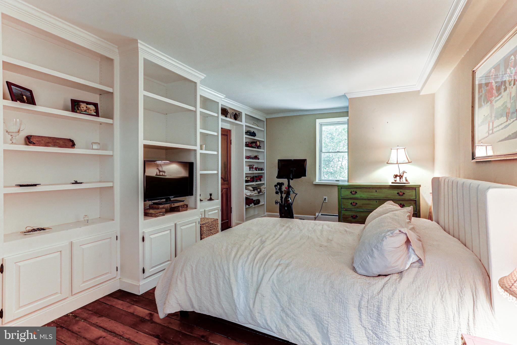 1427 Flint Hill Road Landenberg, PA 19350 - Photo 65 of 85 a bedroom with a large bed and a flat tv screen on dresser