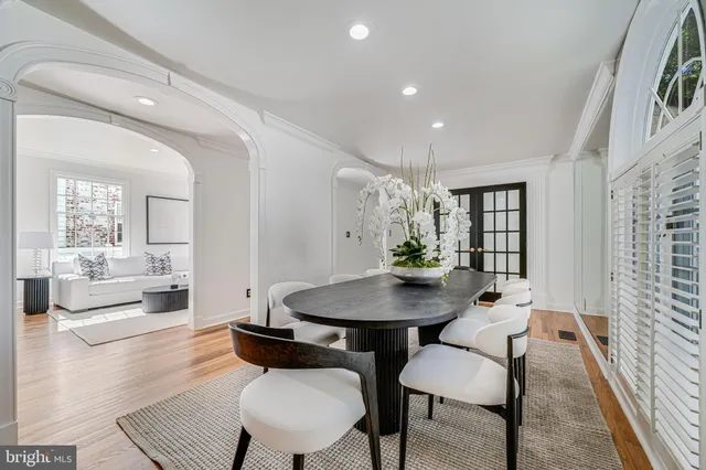 a living room with furniture a fireplace and a large window