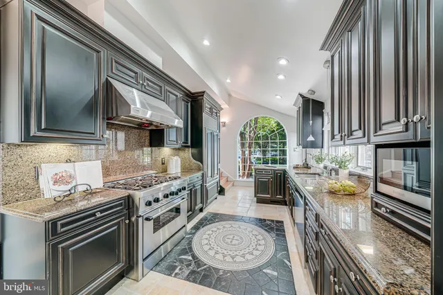 a kitchen with a sink a stove and cabinets