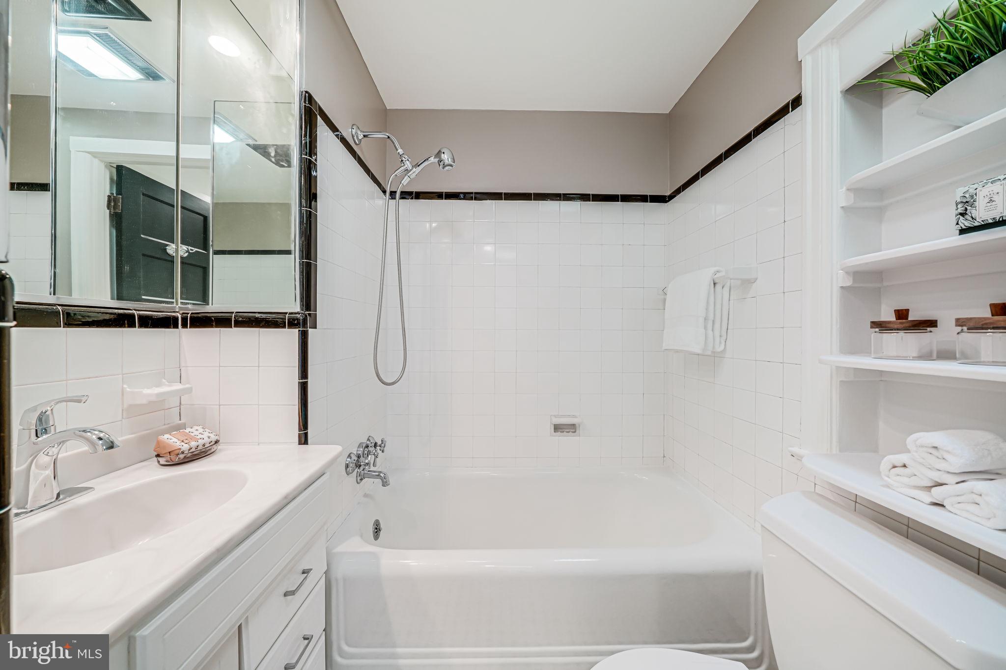4817 Chevy Chase Boulevard Chevy Chase, MD 20815 - Photo 24 of 78 a bathroom with a sink a toilet and shower