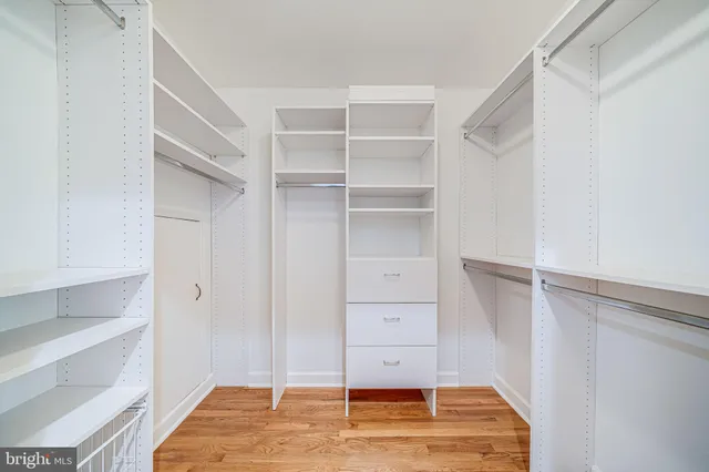 a bathroom with a granite countertop bathtub and window