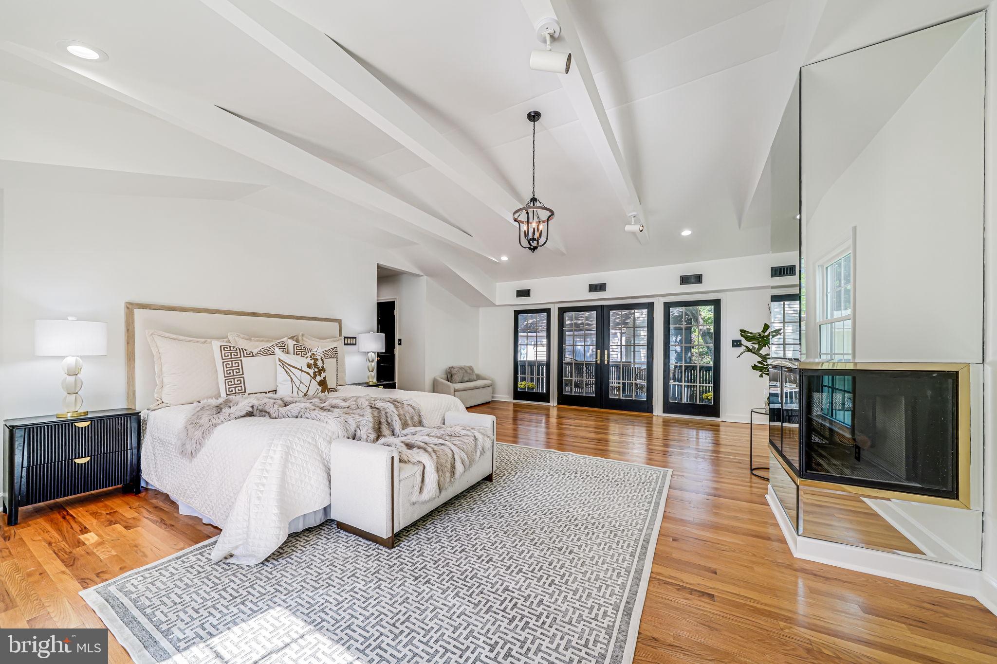 4817 Chevy Chase Boulevard Chevy Chase, MD 20815 - Photo 36 of 78 a bedroom with a large bed and a wooden floor