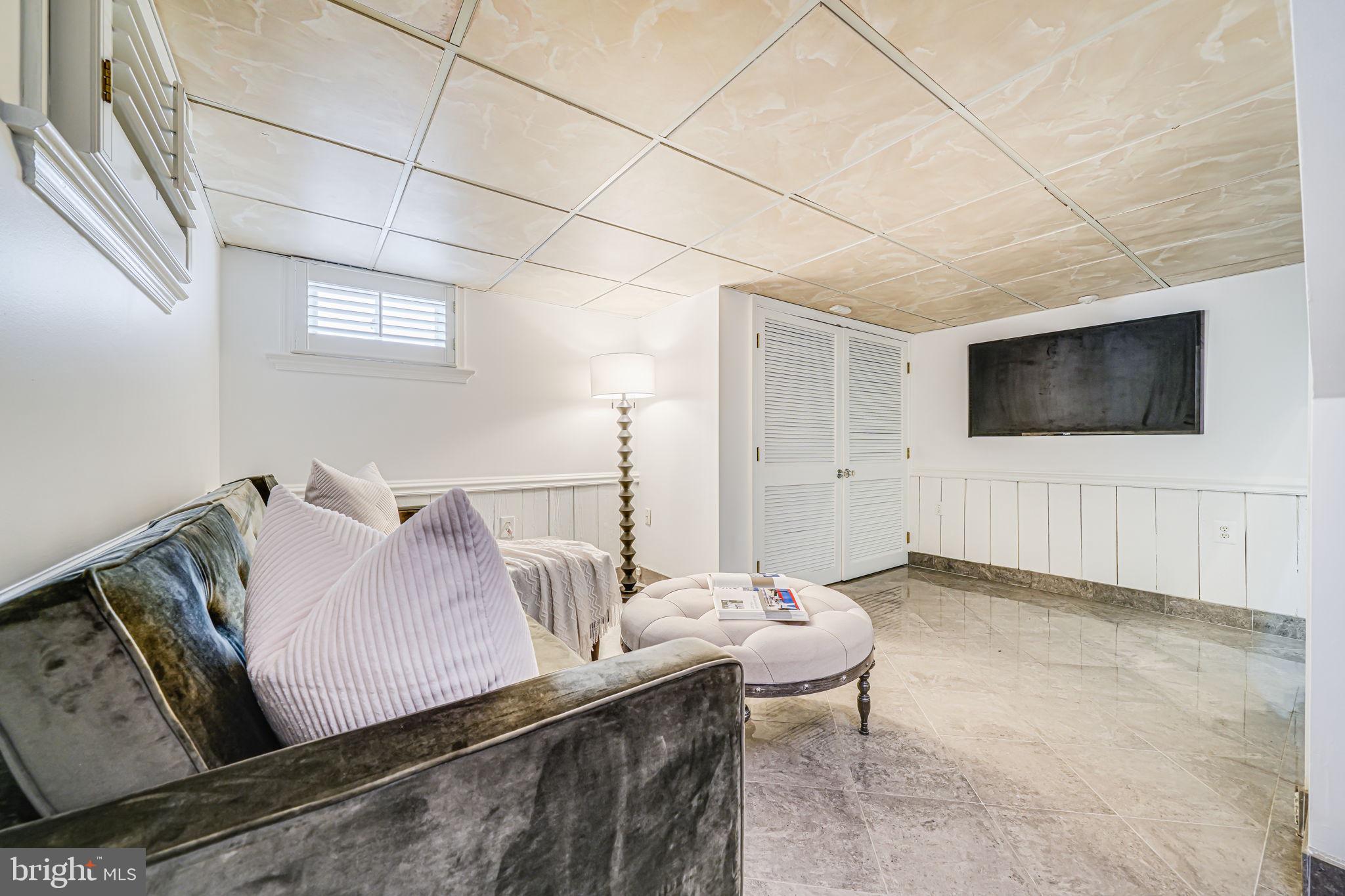 4817 Chevy Chase Boulevard Chevy Chase, MD 20815 - Photo 40 of 78 a living room with furniture and a flat screen tv
