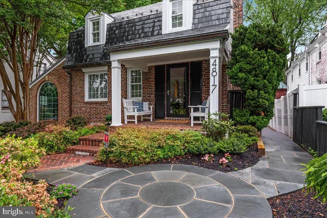 a view of a house with potted plants