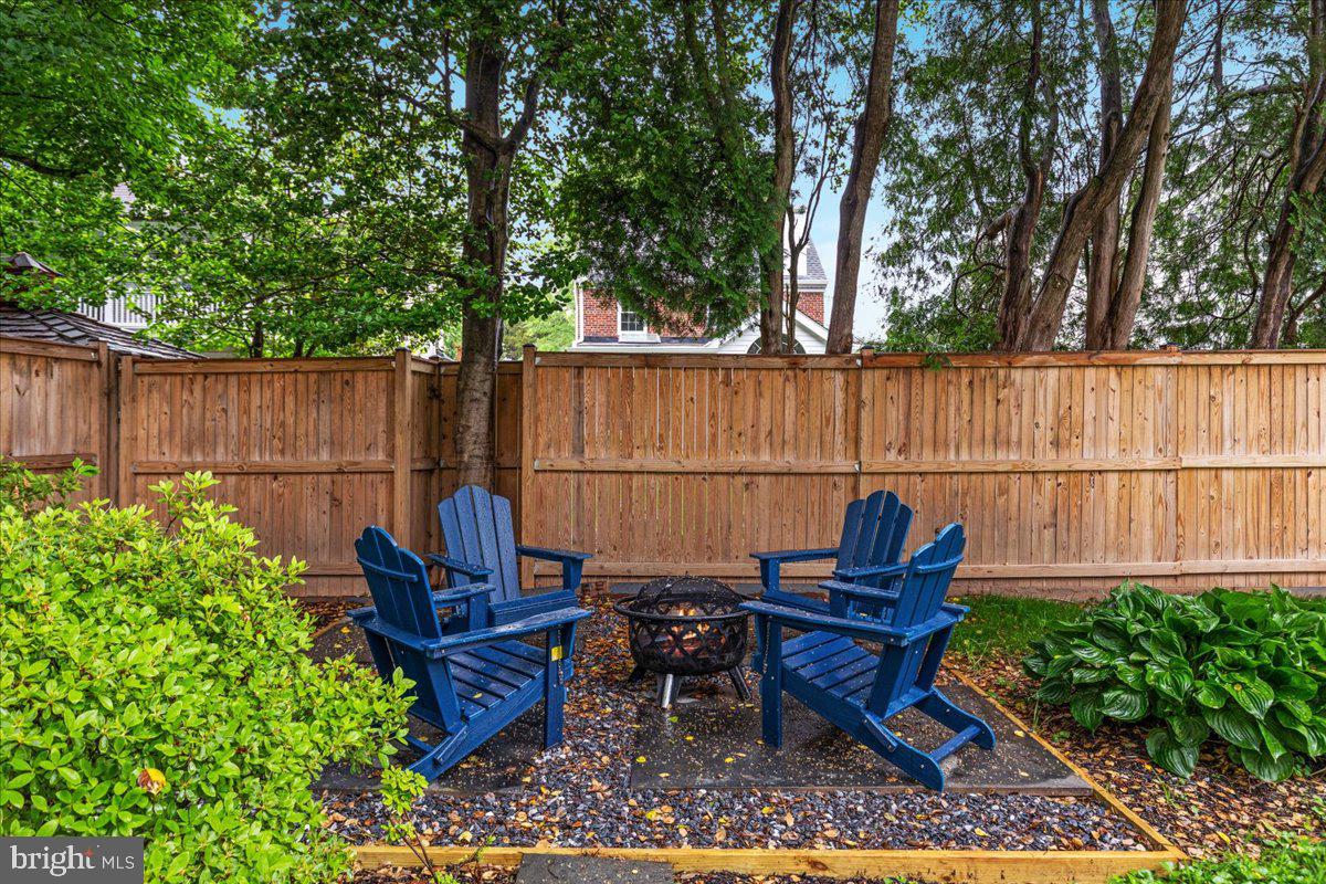 4817 Chevy Chase Boulevard Chevy Chase, MD 20815 - Photo 45 of 78 a backyard of a house with a garden and outdoor seating