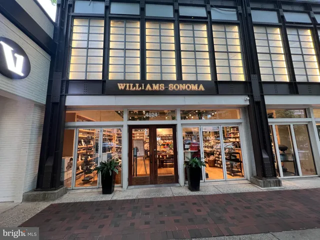 a man walking down a street next to a building