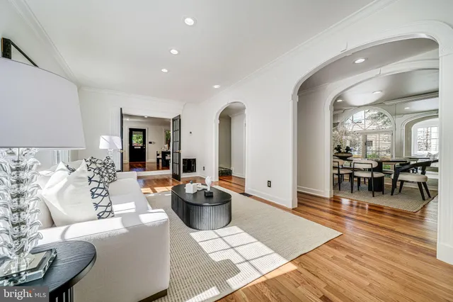 a view of a hallway with wooden floor and windows