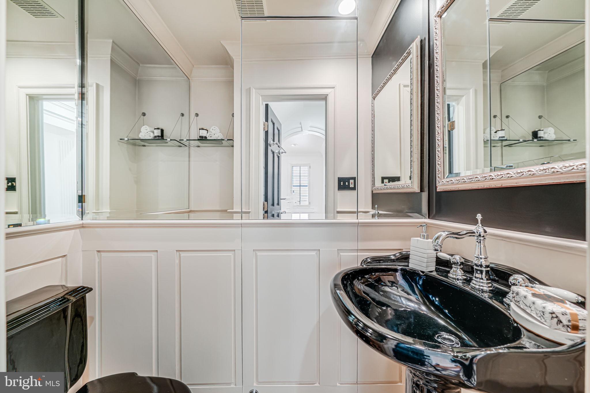 4817 Chevy Chase Boulevard Chevy Chase, MD 20815 - Photo 10 of 78 a bathroom with a sink and a mirror