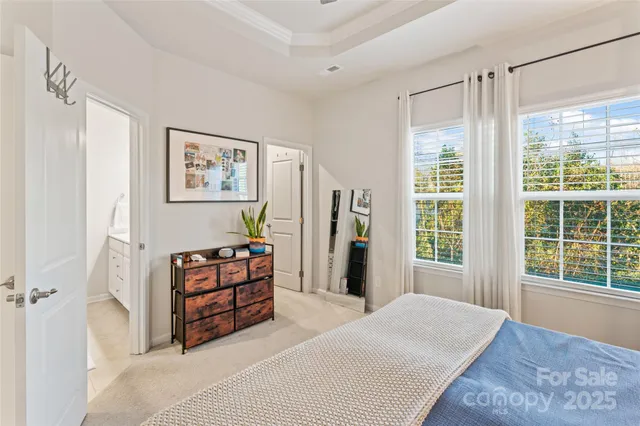 a spacious bedroom with a bed and a window