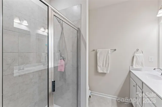 a bathroom with a shower sink and mirror