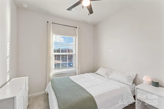 a bedroom with a bed and a chair