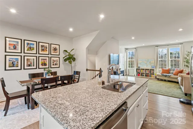 a kitchen with center island table and chairs