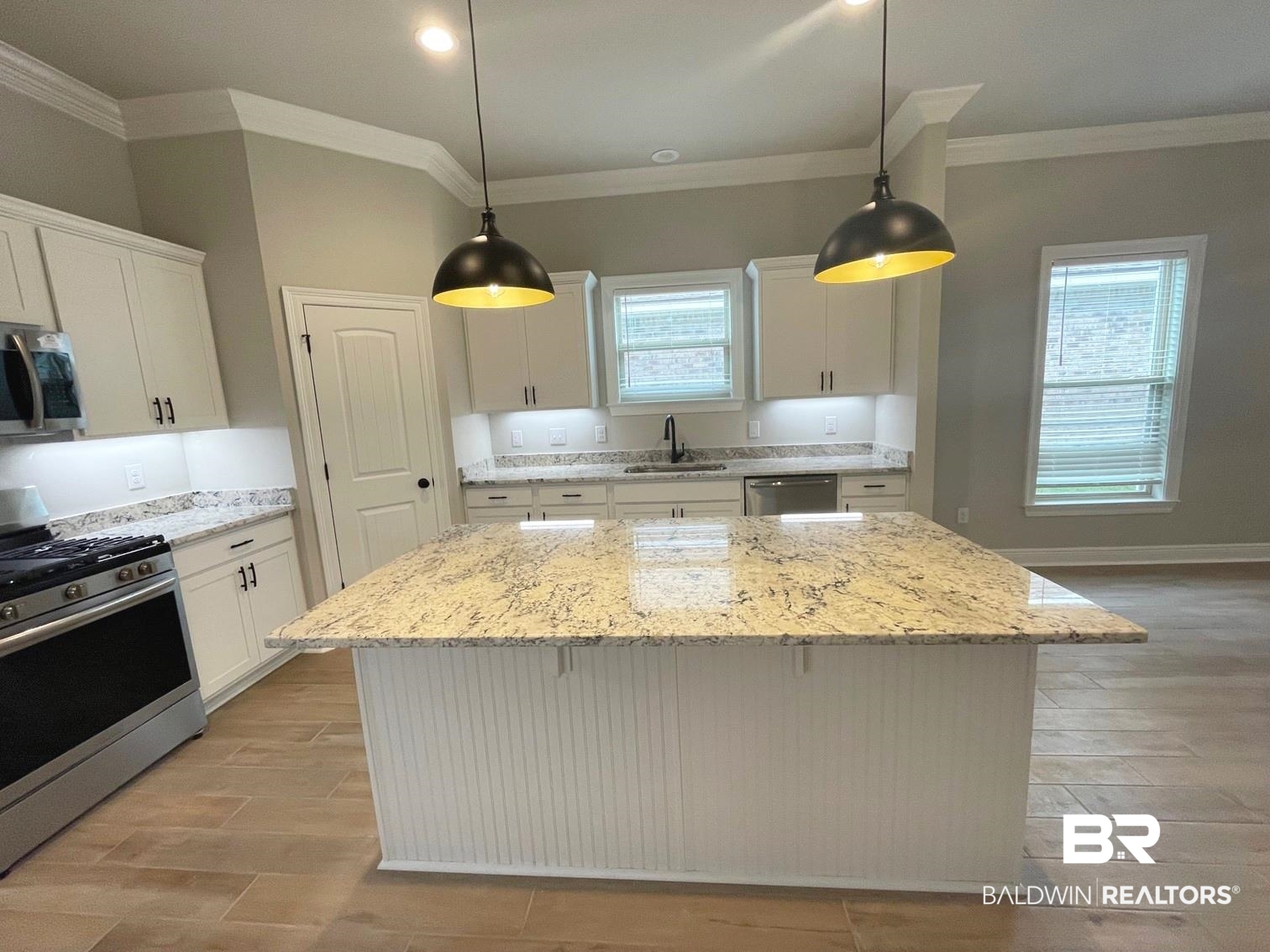 1412 Fenton Circle Foley, AL 36535 - Photo 2 of 15 Kitchen featuring stainless steel appliances, white cabinetry, and a center island