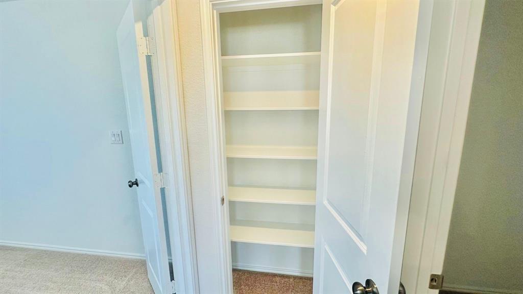 192 Rodney Boat Road Kyle, TX 78640 - Photo 26 of 38 Functional built-in shelving offers ample storage, enhancing this space's practicality.
