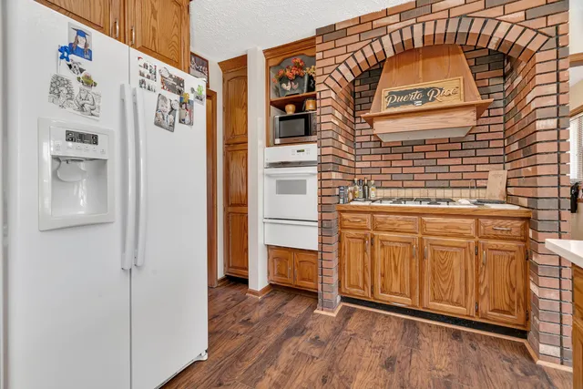 a kitchen with stainless steel appliances granite countertop a stove and a sink