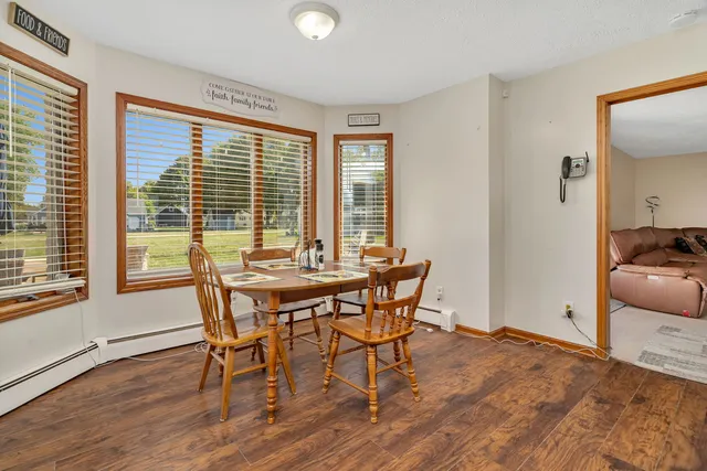 a dining room with furniture and wooden floor