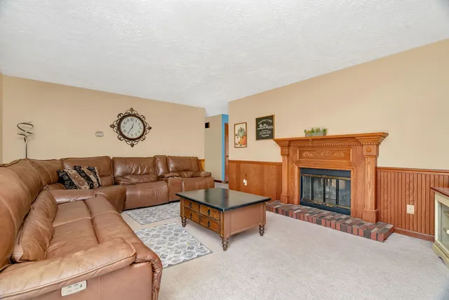 a bathroom with a granite countertop toilet sink and mirror