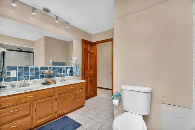 a bathroom with a toilet a sink and a mirror