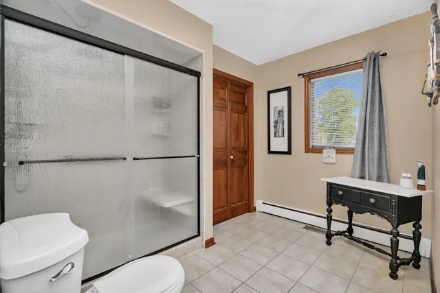 a bedroom with a bed and a ceiling fan