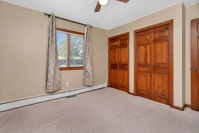 an empty room with windows and closet