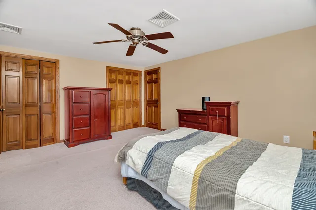 a bedroom with a bed and dresser