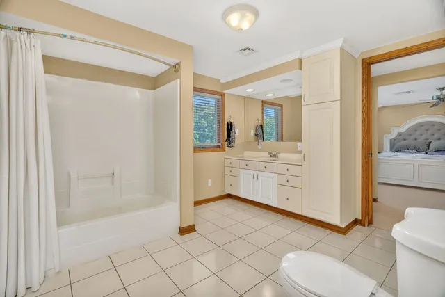 a spacious bedroom with a bed and a view of room