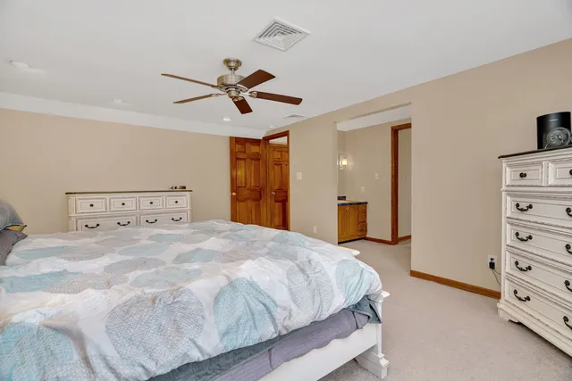 a bedroom with a bed and dresser