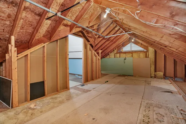 a view of a patio with table and chairs and potted plants with wooden floor and fence
