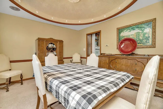 a view of a dining room with furniture and window