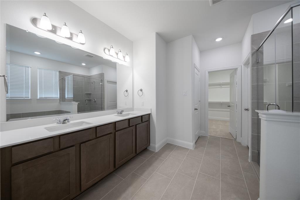 102 National Court Forney, TX 75126 - Photo 11 of 26 a bathroom with a double vanity sink mirror and shower