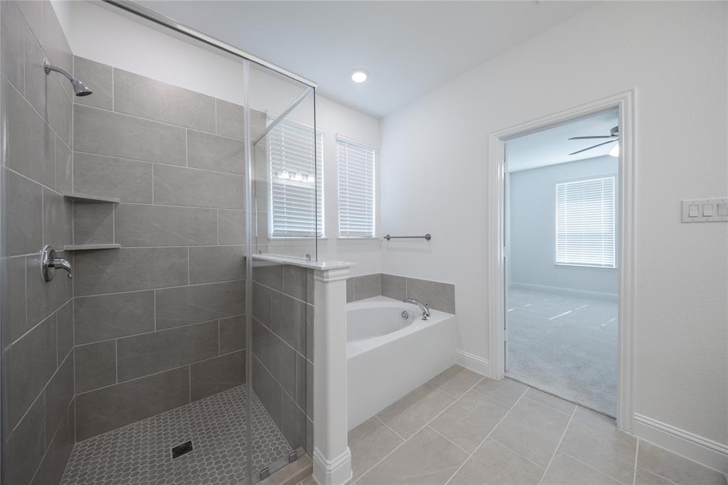 102 National Court Forney, TX 75126 - Photo 12 of 26 a bathroom with a tub shower and vanity