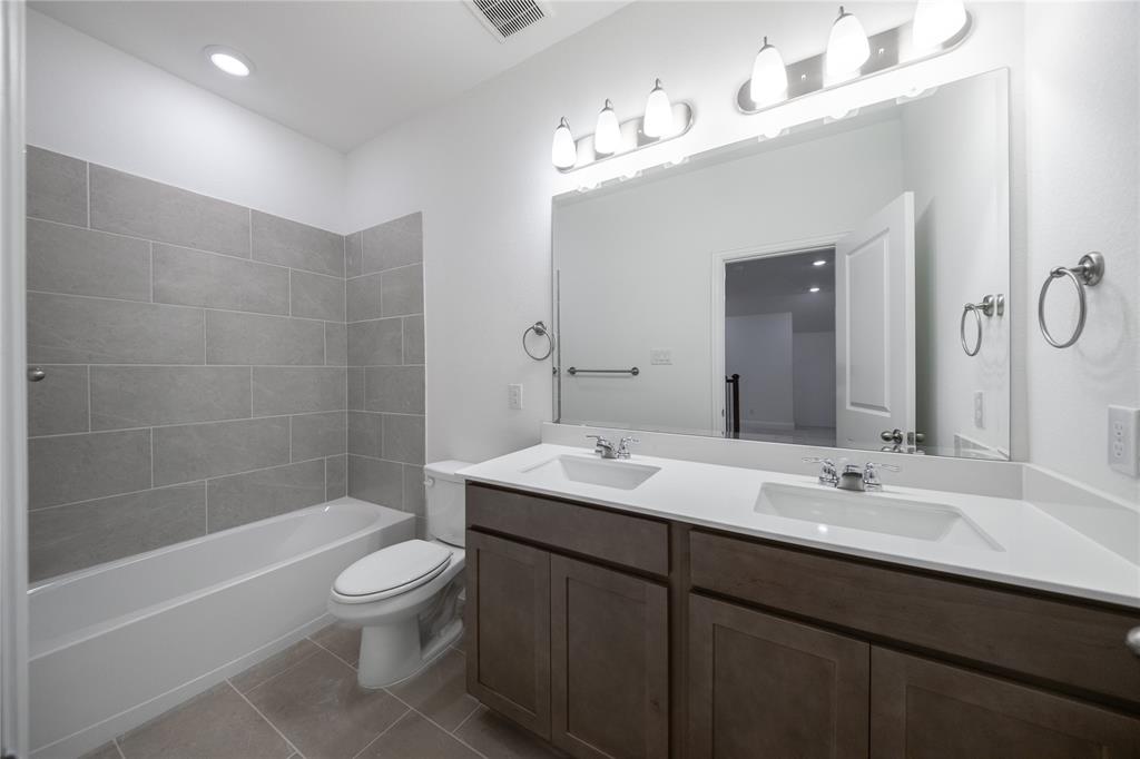 102 National Court Forney, TX 75126 - Photo 17 of 26 a bathroom with a sink a toilet and shower