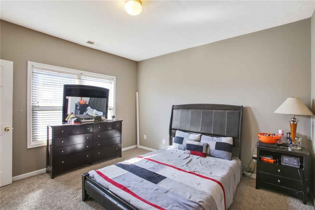 2555 Flat Shoals Road, Unit 1801 Atlanta, GA 30349 - Photo 12 of 24 a bedroom with a bed and a dresser